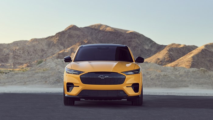 Yellow Ford Mustang Mach-E SUV in desert landscape