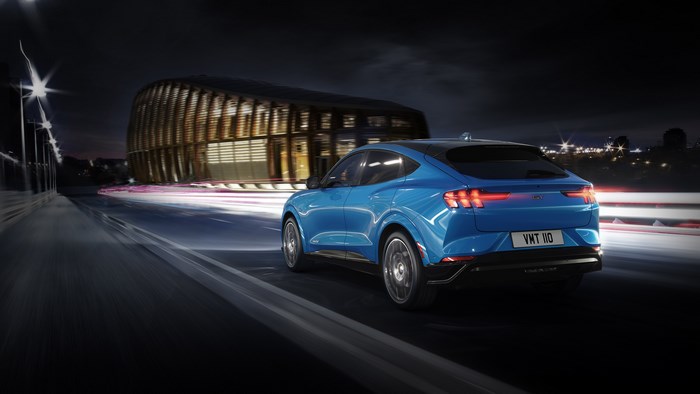 Blue Ford Mustang Mach-E driving at night