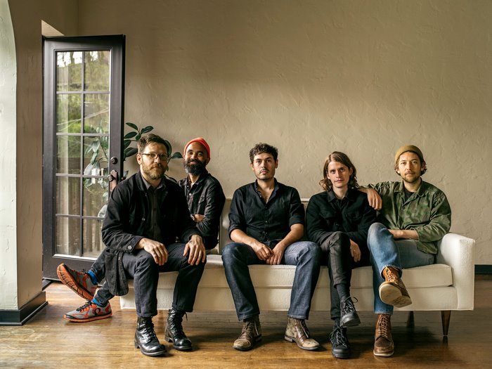 Fleet Foxes band members sitting on a couch
