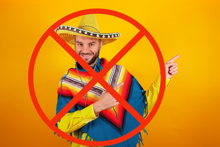 Man in sombrero and poncho with prohibition sign