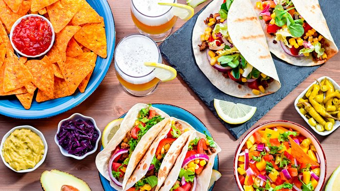 Mexican Food Spread with Tacos, Nachos, and Drinks