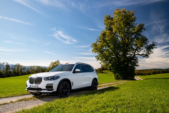 White BMW X5 SUV on a dirt road