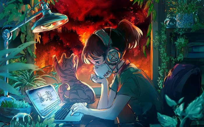 Girl with headphones and mask working on laptop with cat