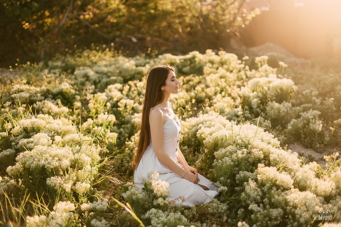 Serene Woman in White Dress Among Flowers
