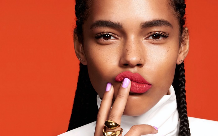 Woman with red lipstick and purple nails