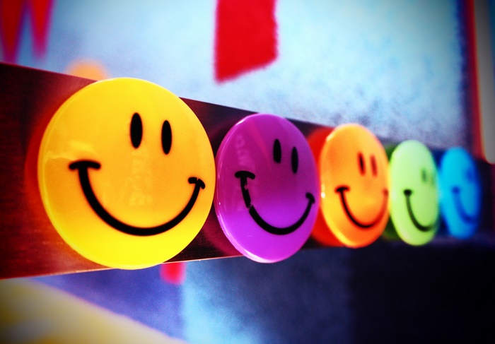 Row of colorful smiley face magnets