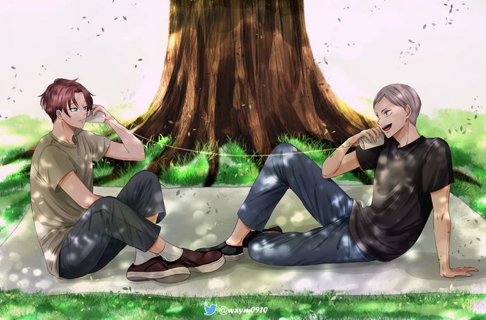 Two boys talking on tin can phones under a tree