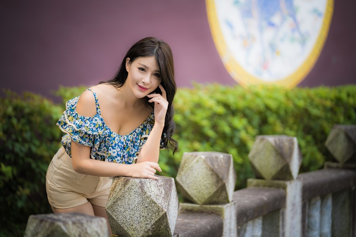 Asian Woman in Floral Top and Shorts