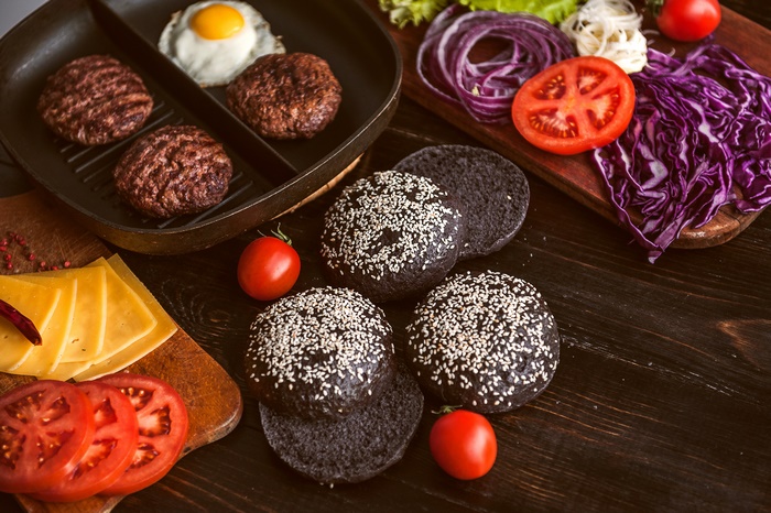 Burger Ingredients on a Dark Wooden Table