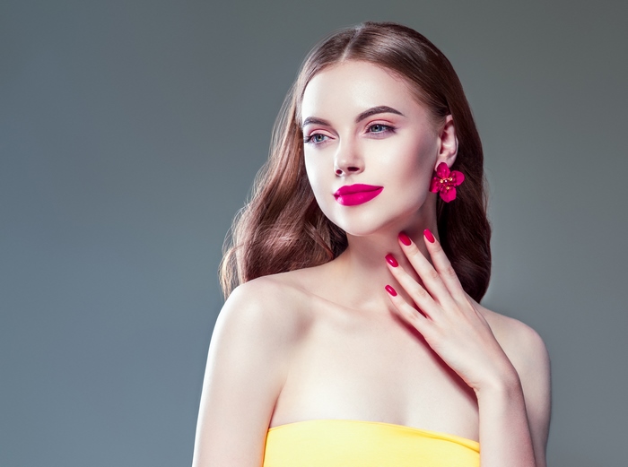 Elegant Woman with Vibrant Pink Makeup and Accessories