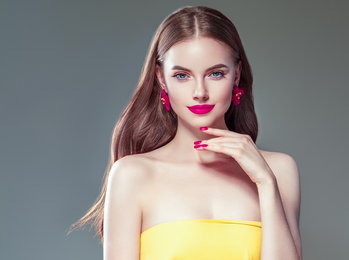 Woman with pink lipstick and yellow top