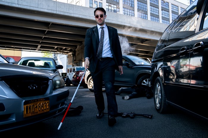 Matt Murdock with a cane on a street