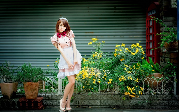 Woman in Maid Outfit Poses Outdoors
