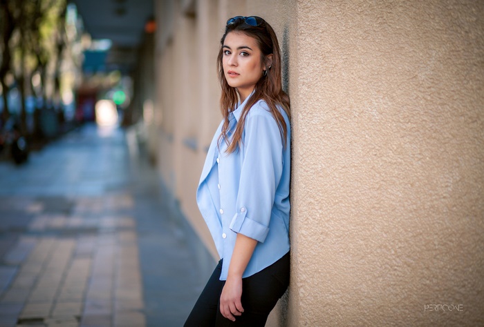 Woman leaning against a wall
