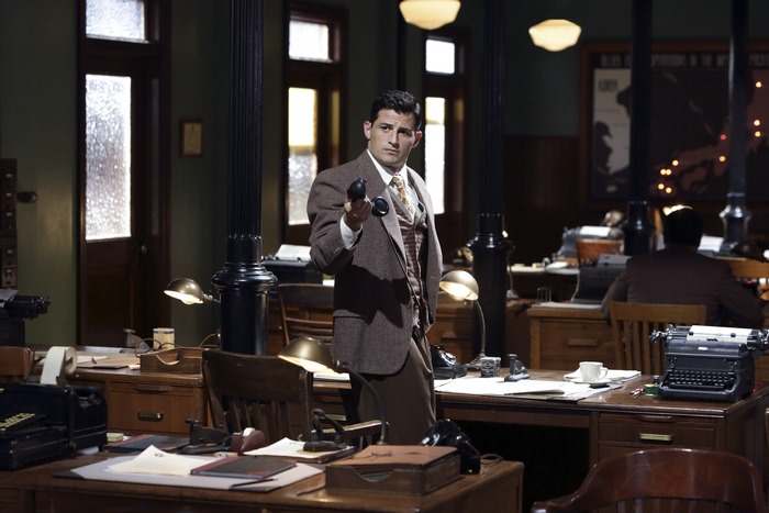 Daniel Sousa holding a phone in an office