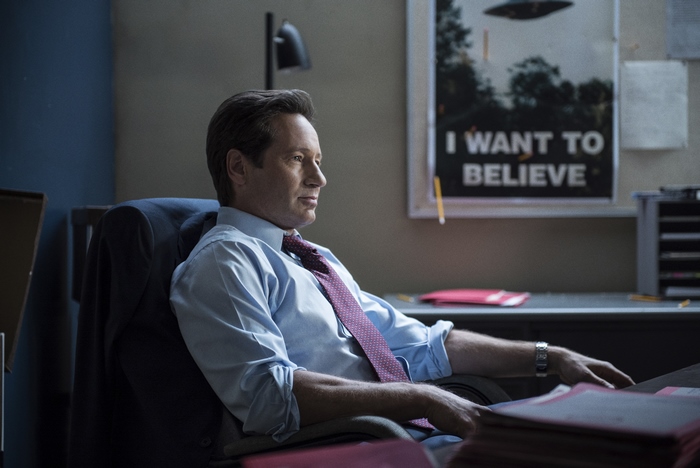 Fox Mulder in his office with 'I Want to Believe' poster