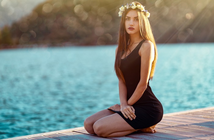 Woman with flower crown on a dock