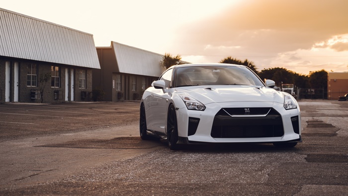 White Nissan GT-R parked in front of motel