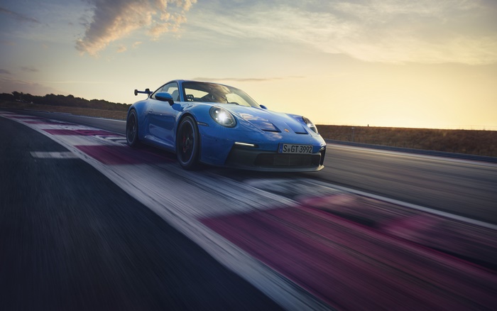 Blue Porsche 911 GT3 (992) on a Racetrack