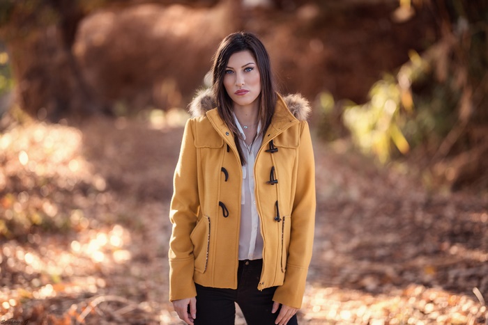 Woman with blue eyes wearing a yellow coat