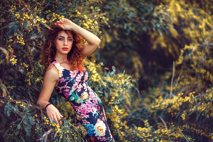 Woman in floral dress with curly hair