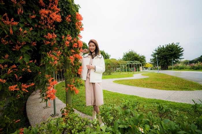 Asian Woman Posing Near Orange Flowers