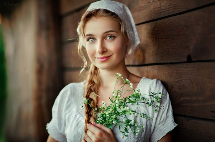 Woman with Braid Holding Flowers