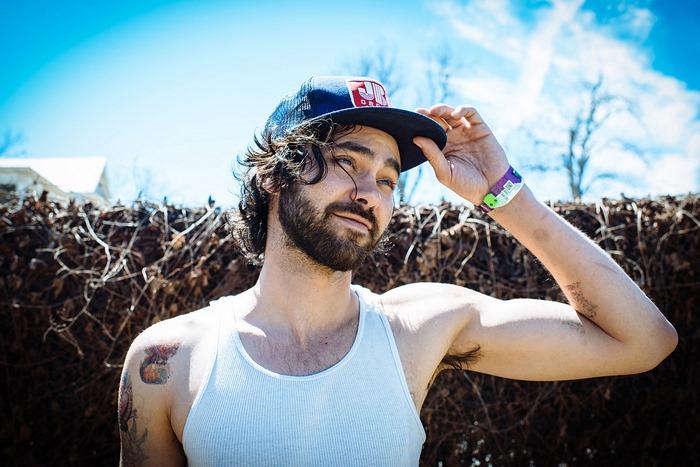 Shakey Graves wearing a trucker hat and tank top