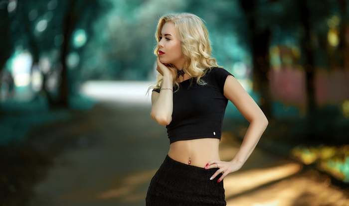 Blonde woman in black crop top and skirt
