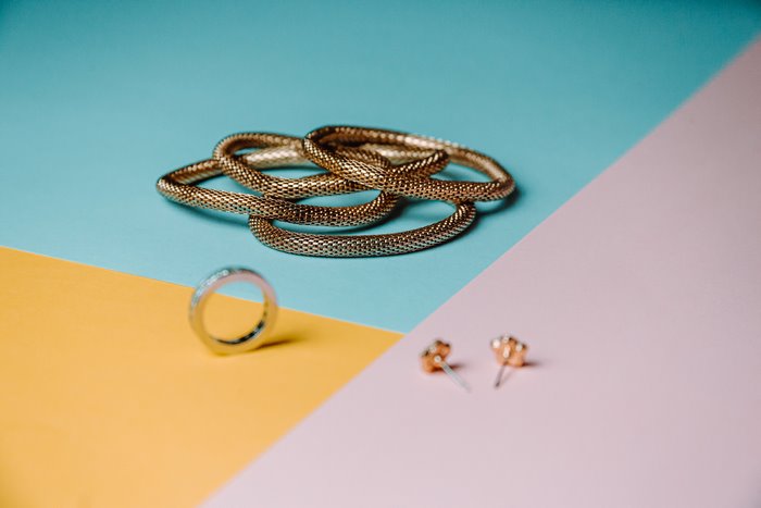 Gold jewelry on a colorful background