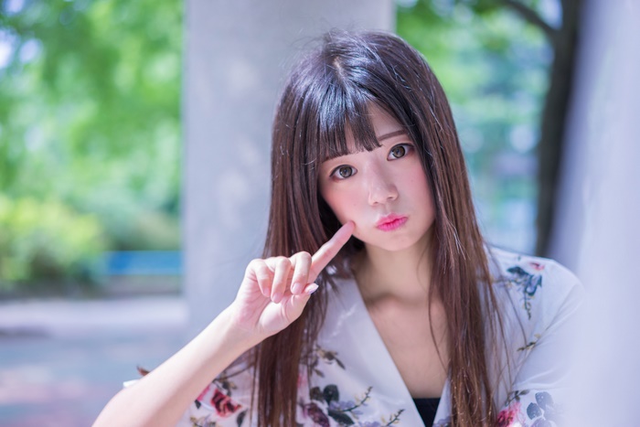 Asian woman with long dark hair and bangs