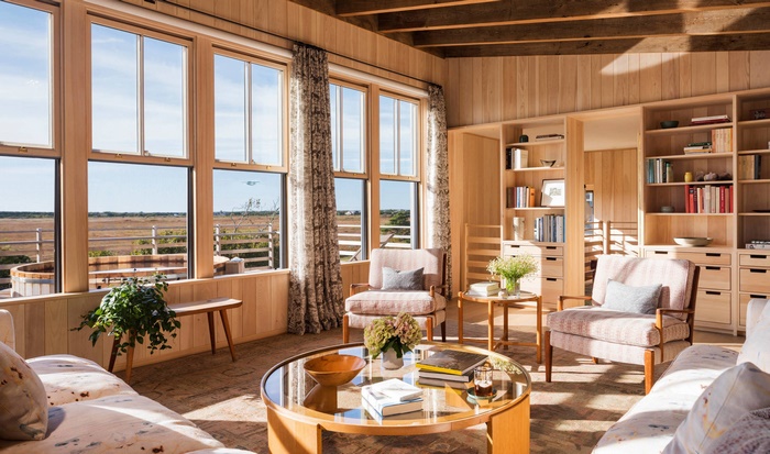 Living room with large windows and bookshelves