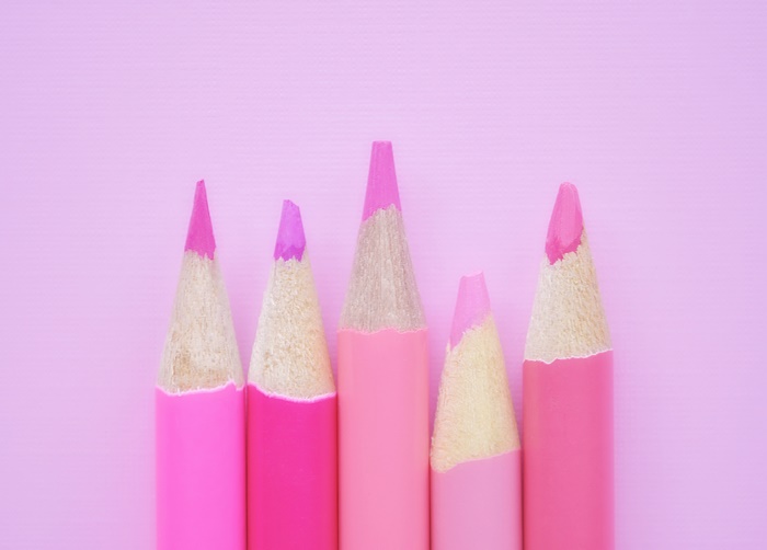 Pink colored pencils on a pink background