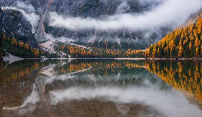 Lake with Autumn Trees and Foggy Mountains Reflection