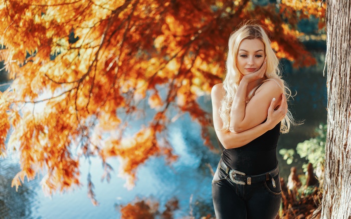 Blonde Woman Posing by a Lake in Autumn
