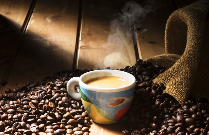 Espresso cup with coffee beans and burlap sack