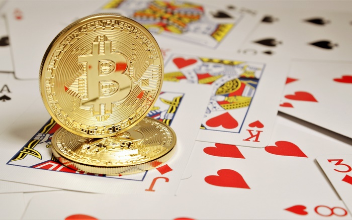 Bitcoin coins on playing cards