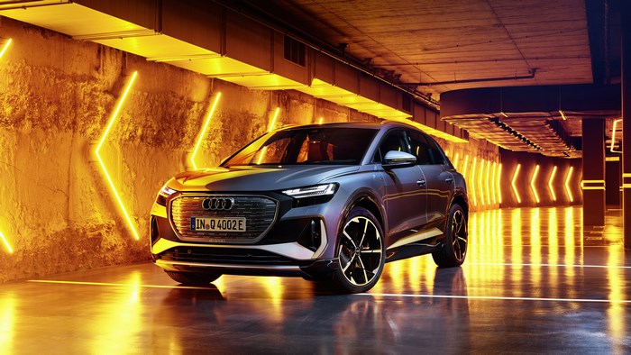 Audi Q4 e-tron electric SUV in a neon-lit tunnel