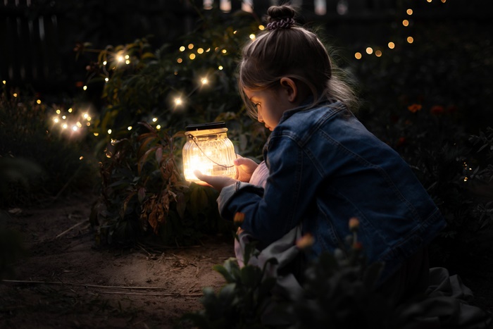 Girl holding a lantern with fairy lights