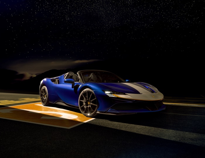 Blue Ferrari SF90 Spider with White Stripes Under Stars