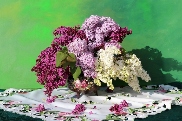 Bouquet of lilacs in a decorative vase on a table