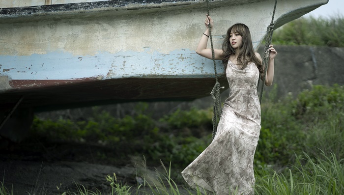 Brunette Woman in Elegant Dress on Swing