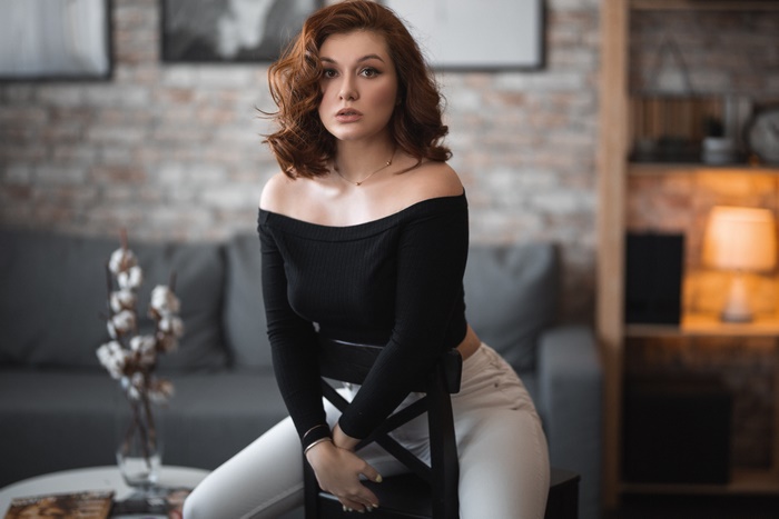 Woman with Red Hair Posing on a Chair