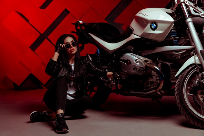 Woman in leather jacket with BMW motorcycle