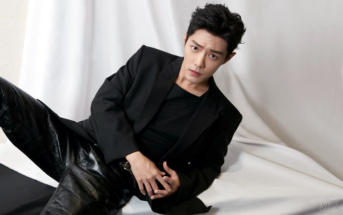 Xiao Zhan in a black suit and leather pants