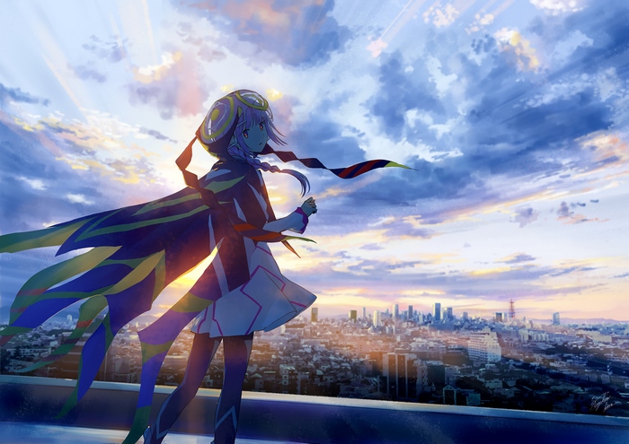 Kaf stands on a rooftop overlooking a city at sunset