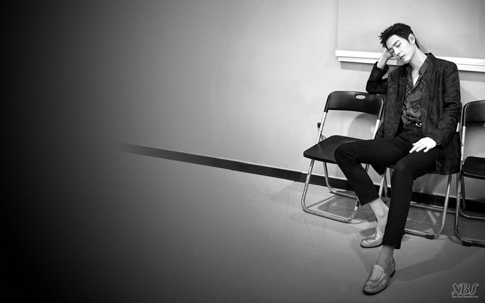 Xiao Zhan sitting on a chair