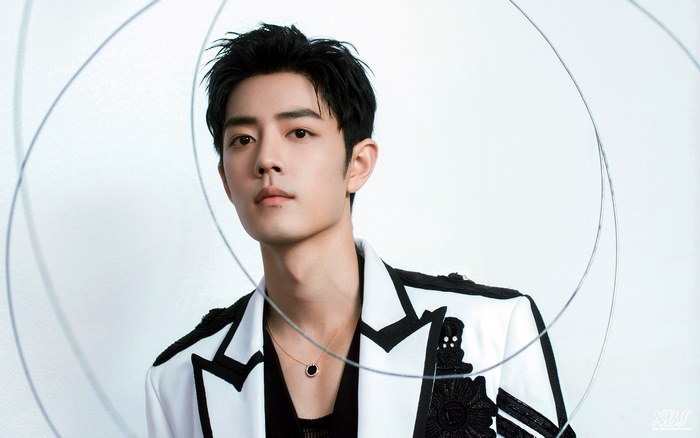 Xiao Zhan in a white and black jacket