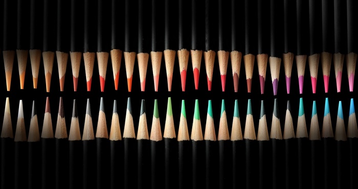 Close-up of sharpened colored pencils in two rows