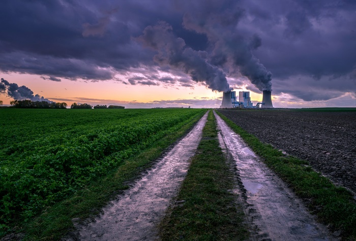 Power Plant Emitting Smoke at Sunset